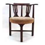 A George III oak corner chair with an upholstered curved seat on square straight legs joined by a