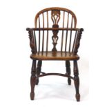 A late 18th/early 19th century double hoop Windsor armchair with an elm seat,