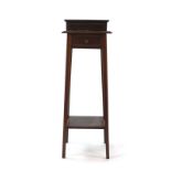 An Edwardian mahogany and strung plant stand with a single drawer and second tier on square