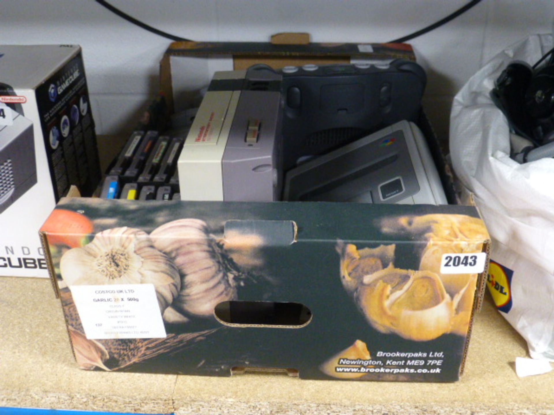 Cardboard tray containing various Nintendo consoles include NES, Super NES and Nintendo 64