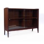 A Younger afromosia bookcase with two glazed sliding doors on integral feet, l.