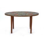 A 1970's occasional table of oval form, the surface with a floral mosaic, l.