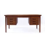 A 1960's teak desk, the rectangular surface over a pair of suspended three-drawer pedestals,