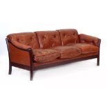 A 1970's Danish three-seater sofa in dark red with an exposed stained beech frame of circular form