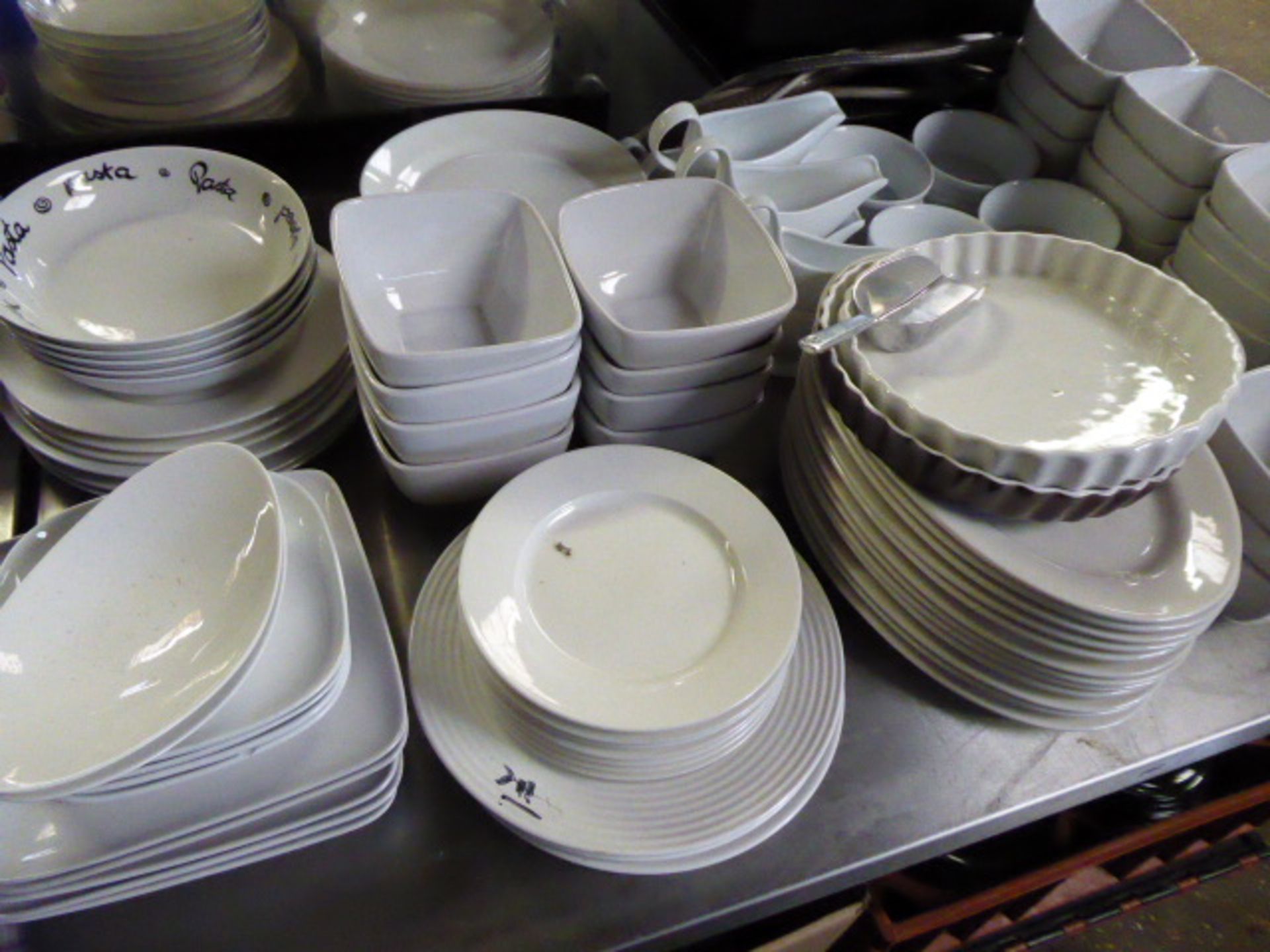 2 tabletops of mainly white crockery with some blue and white, comprising large number of coffee