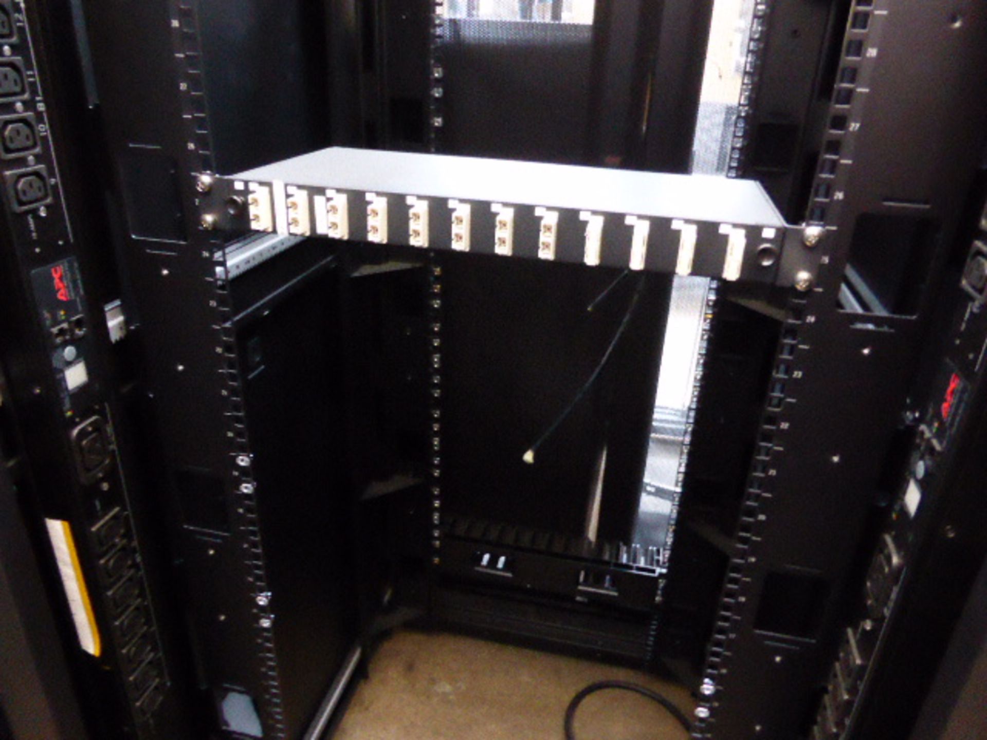 APC server cabinet on castors 75cm wide with 2 APC switch rack PDU units each with 24 outputs on - Image 2 of 2