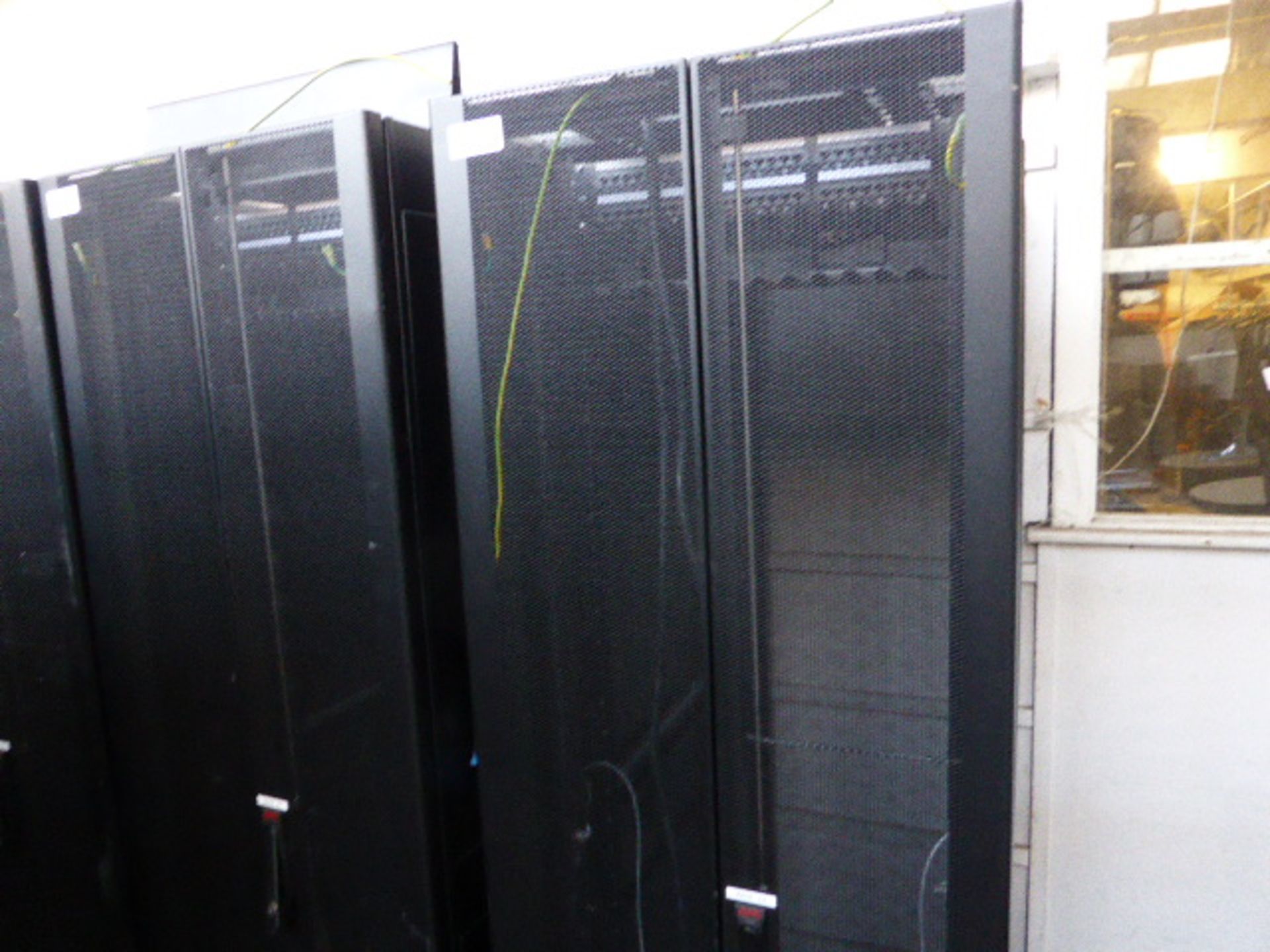 APC server cabinet on castors 60cm wide with 2 APC switch rack PDU units each with 24 outputs on