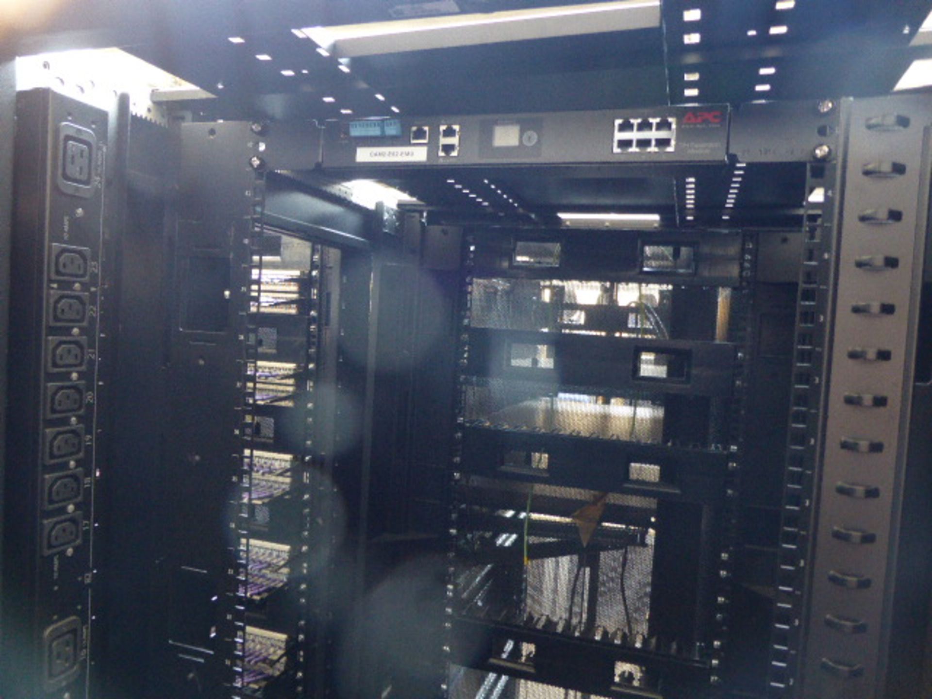 APC server cabinet on castors 75cm wide with 2 APC switch rack PDU units each with 24 outputs on - Image 2 of 3