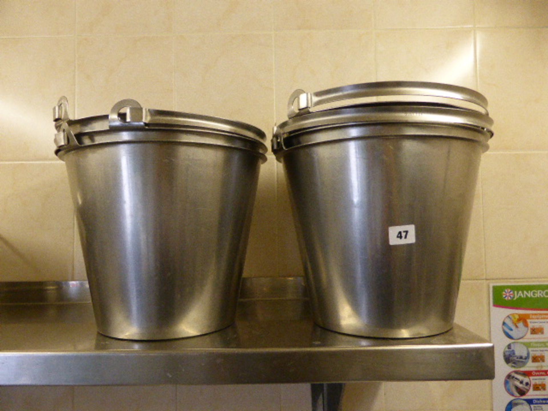 Five stainless steel buckets with handles