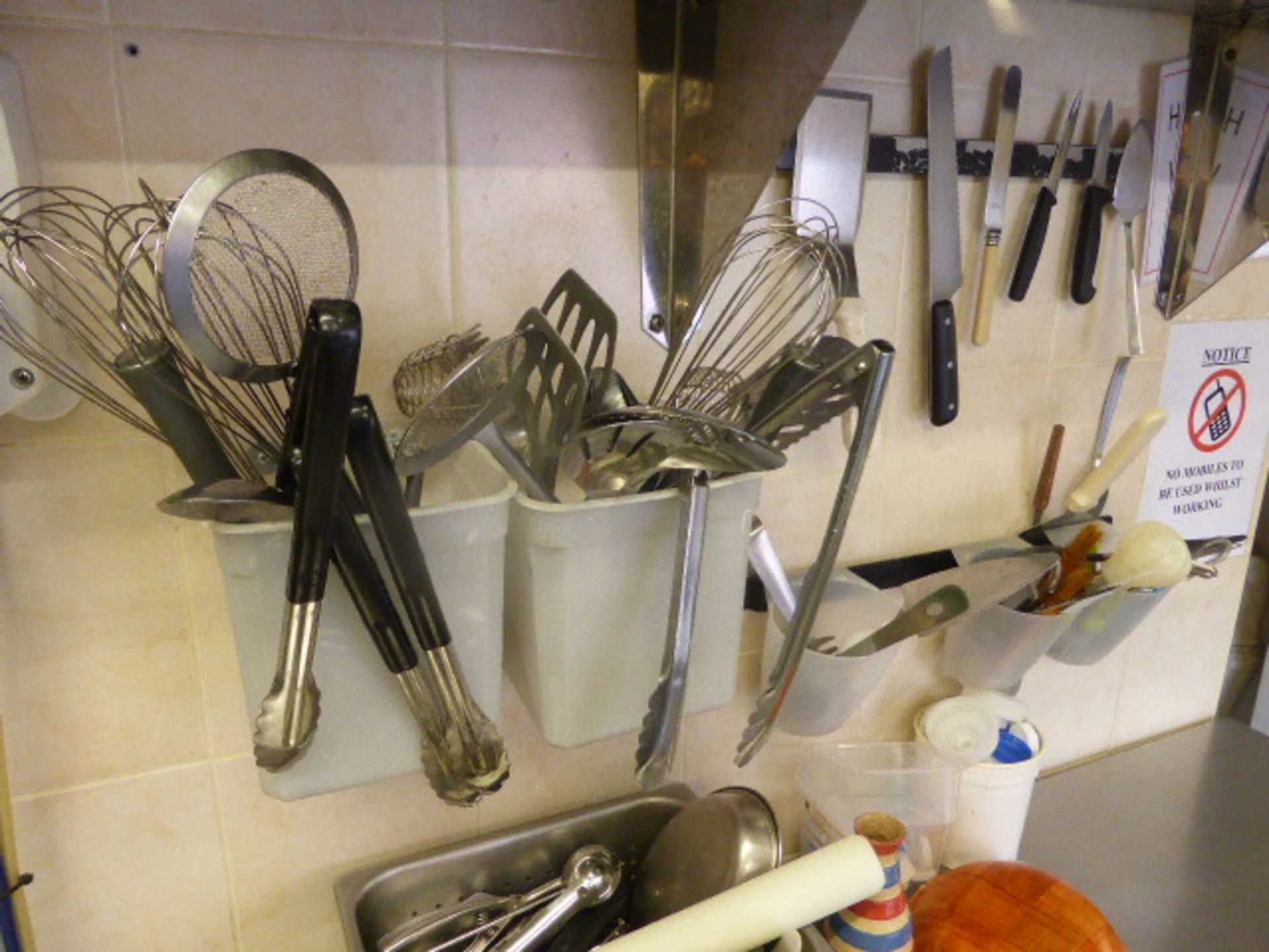 Range of utensils in dish wash area including serving tongs, whisks, pasta spoons, slotted spoons, - Image 3 of 4