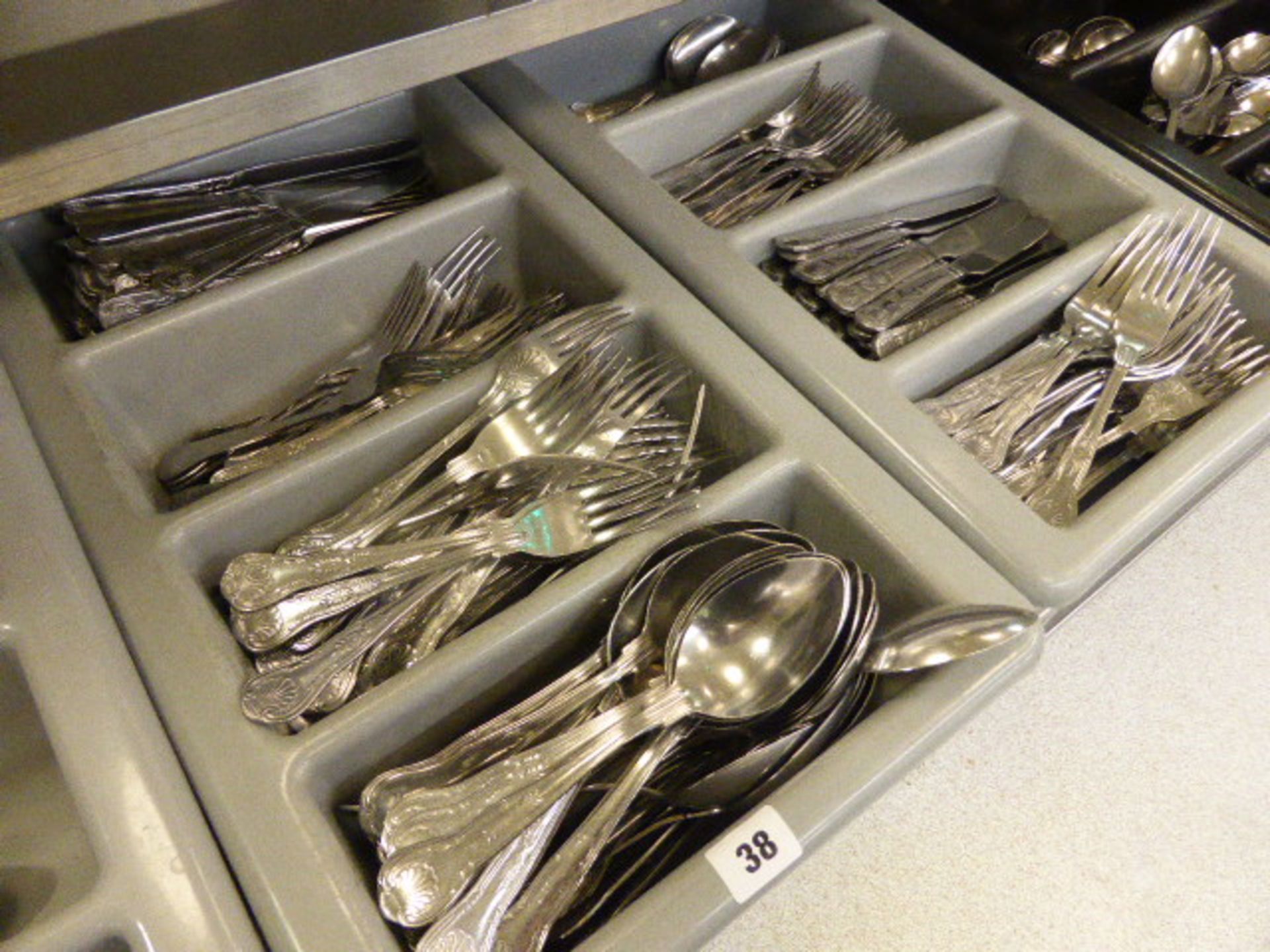 Three grey 4 section cutlery trays and 1 black 4 section cutlery tray; with a large qty of Kings