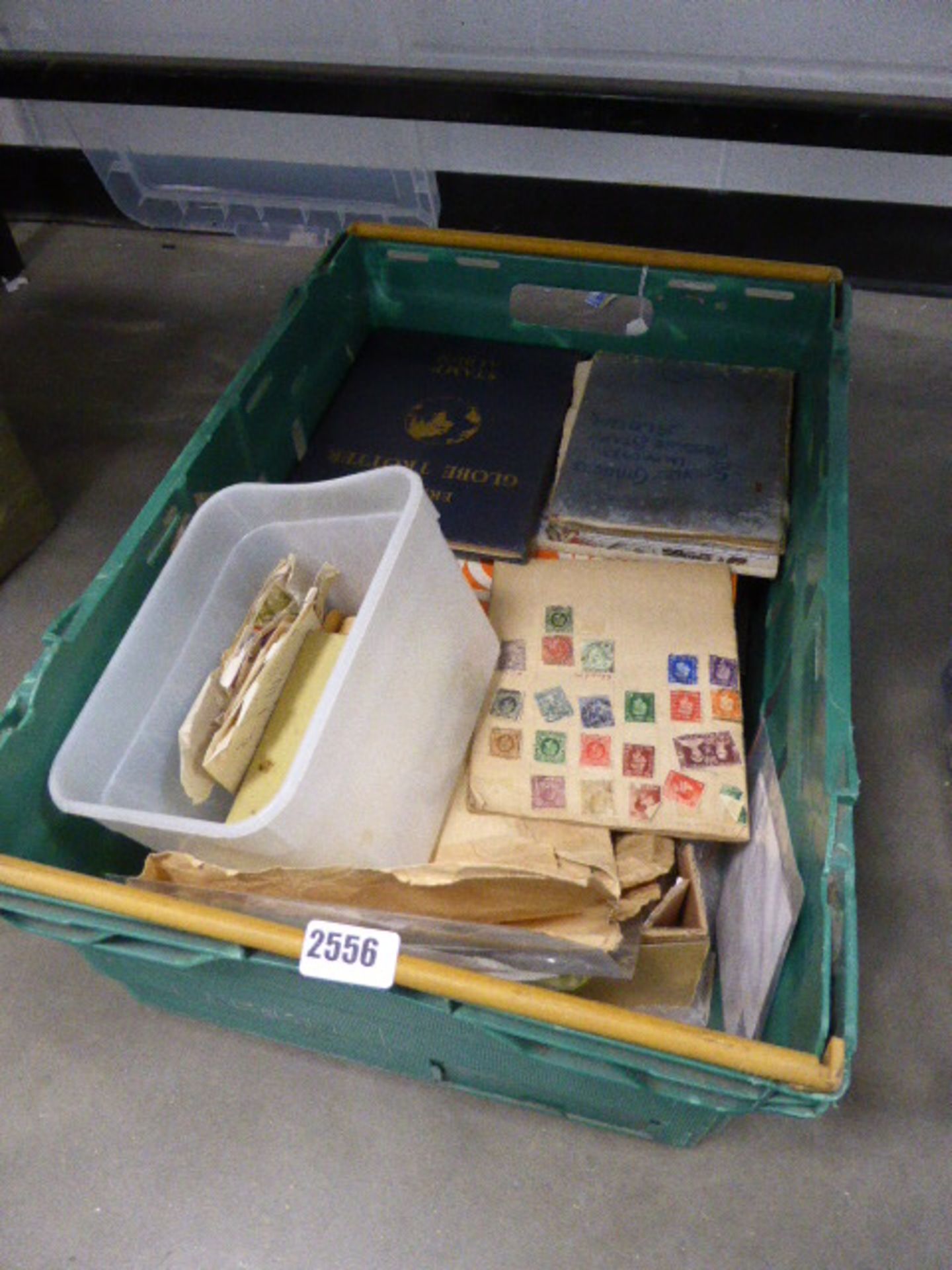 Large green crate of stamps and stamp albums