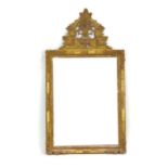 A wall mirror, the rectangular plate within a giltwood frame,