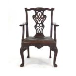 A late 18th/early 19th century mahogany carver armchair in the Chippendale manner with a leather