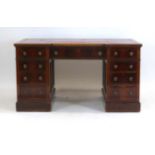 A Victorian mahogany twin-pedestal desk, the breakfront top with a tooled leather surface,