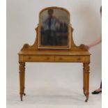 An Edwardian satinwood dressing table with an arched mirror over the pair of drawers,