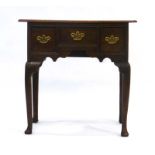 An 18th century and later oak lowboy,