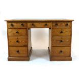 A late 19th/early 20th century pitched pine twin-pedestal desk,