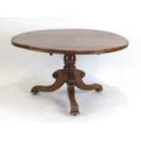 A 19th century mahogany and rosewood crossbanded centre table on a turned pillar with three