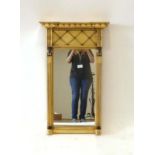 A Georgian-style giltwood and ebonised wall mirror,