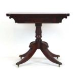 A 19th century mahogany card table, the folding top over a shaped frieze,