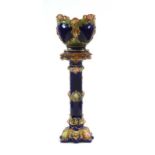A Royal majolica jardiniere and stand decorated in the rococo manner in shades of blue,