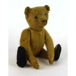An early 20th century fully jointed Steiff bear having black boot button eyes and button to ear, l.