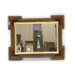 A wall mirror, the rectangular plate within a giltwood and velour frame of castellated form, h.