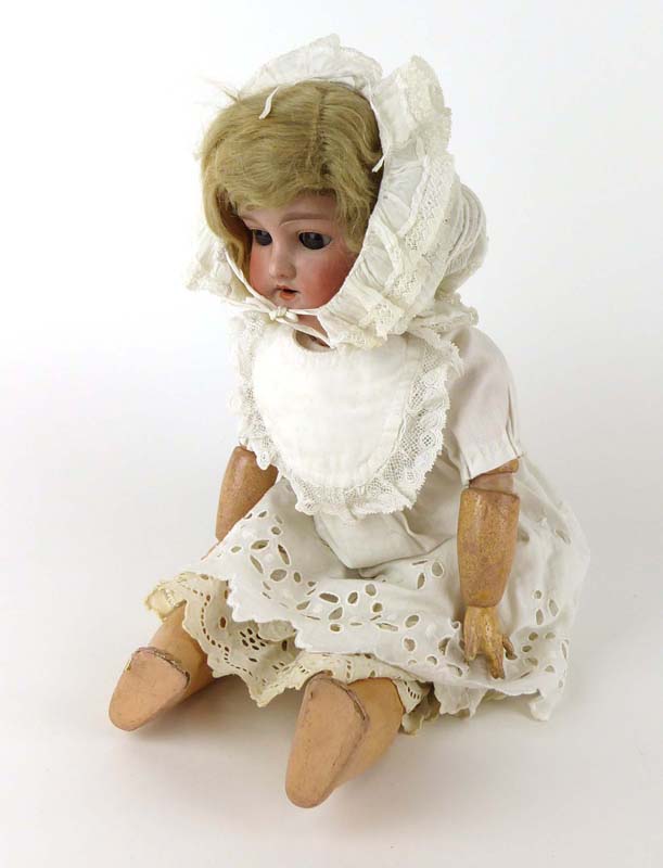 An Armand Marseille bisque headed doll with fixed brown glass eyes and open mouth,