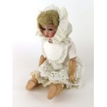 An Armand Marseille bisque headed doll with fixed brown glass eyes and open mouth,