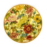 A 19th century charger of circular form decorated by Charlotte Horne Spiers with flowering