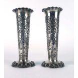 A pair of late Victorian silver spill vases of fluted form repousse decorated with c-scrolls and