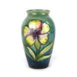 A Moorcroft miniature vase of slender baluster form,