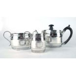 A Victorian silver three piece bachelors tea service of barrel shaped form engraved in the