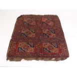 A late 19th/early 20th century Indian rug, the red ground with six medallions within red,