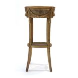 A 19th century gilt plant stand with bergere side panels and swag decoration on splayed legs