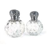 A pair of late Victorian silver mounted cut glass dressing table bottles of spherical form,