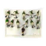 A group of twelve painted and cast figures modelled as a football team including referee