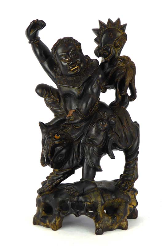 A Chinese hardwood carving modelled as figure riding a qilin, h.