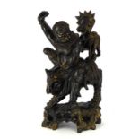 A Chinese hardwood carving modelled as figure riding a qilin, h.