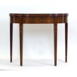 An American reproduction mahogany and marquetry games table with a serpentine front on square