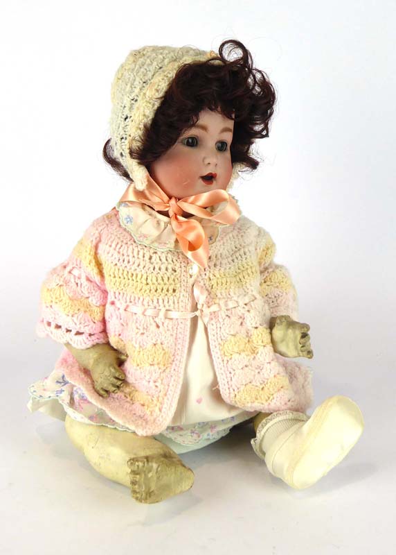 A Schutzmeister & Quendt bisque headed doll with sleeping brown glass eyes and open mouth showing