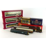A mixed group of Dapol, Bachmann, Hornby and other OO gauge coaches and rolling stock,