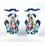 A pair of early 20th century two handled vases of ovoid form decorated with floral sprays, h.