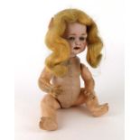 A Heubach Koppelsdorf bisque headed doll with sleeping blue glass eyes and open mouth showing two