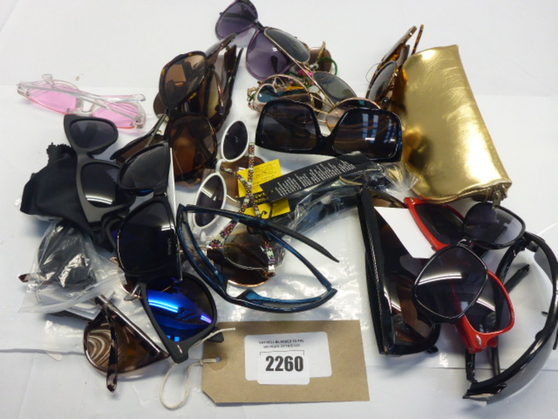 Mixed sunglasses different brands loose in bag.