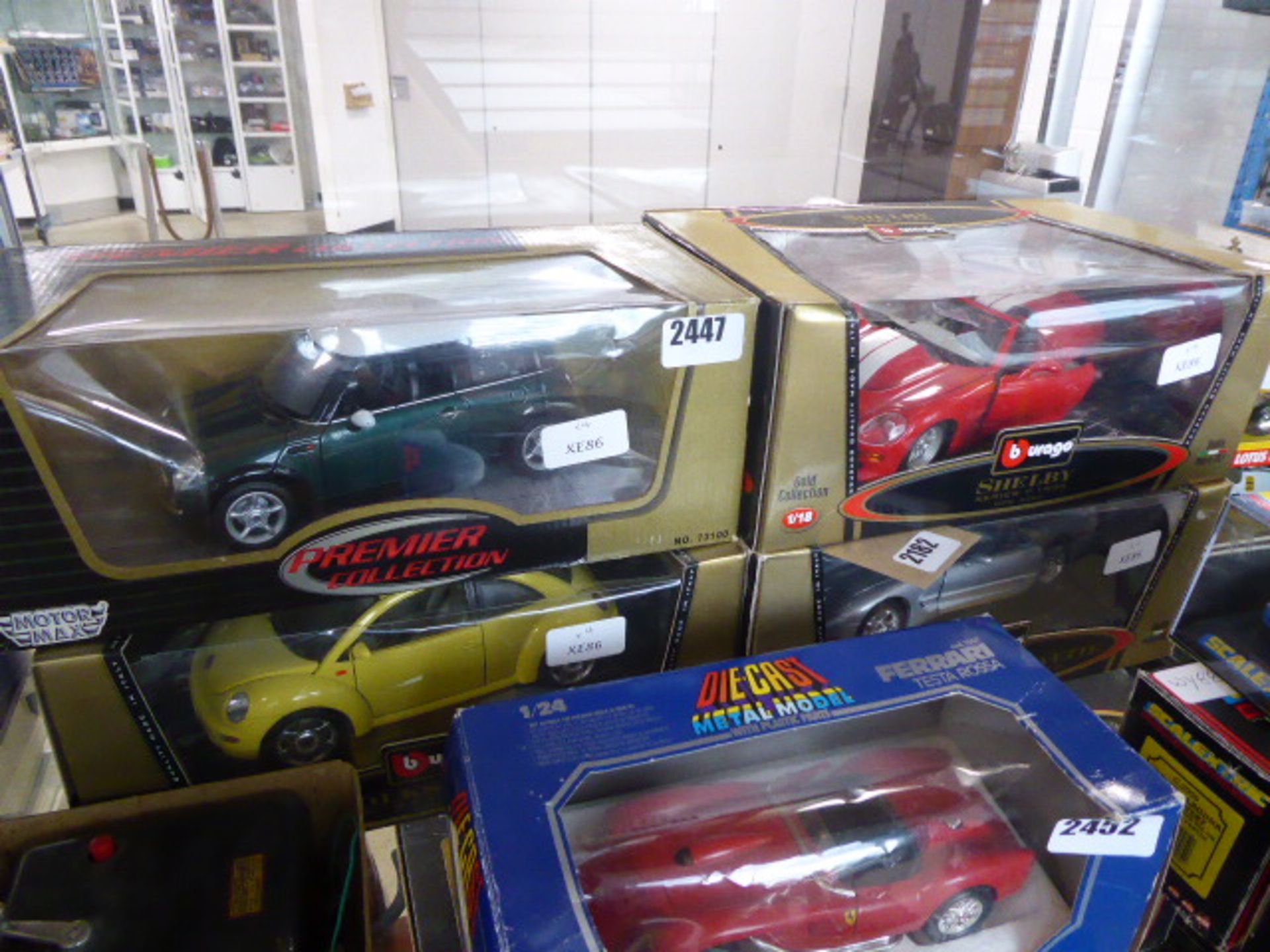 2182 4 x 1:18 scale collectable vehicles in cases including the Shelby Series One, Cheverlot