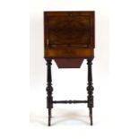 A Victorian figured walnut and ebony strung sewing table with a fitted interior on shaped supports