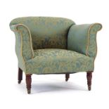 A 19th century and later upholstered lowback armchair on mahogany feet with castors