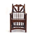 A reproduction oak Wainscott chair with turned pillar supports over a solid seat